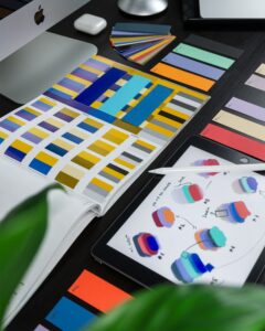 a table with a tablet and color